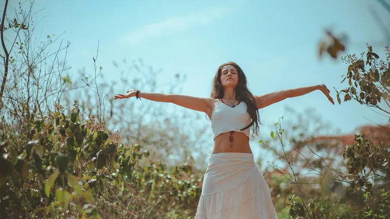 A yoga class in session at the Suniai Oliva Retreat Center, with participants stretching in a bright, airy studio.