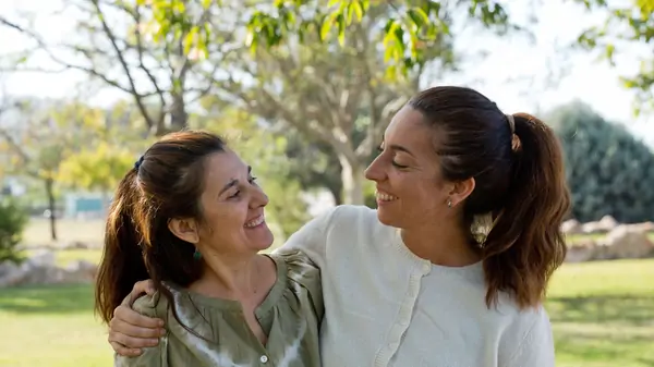 Pilar Lloret and Cecilia Cerza smile at each other in the Suniai Oliva Center, enjoying a sunny day outdoors.
