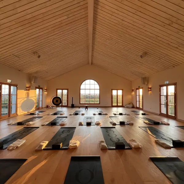 Bright, serene interior of the Suniai Retreat Center in Spain, featuring a gong and yoga mat, perfect for Yoga Classes.