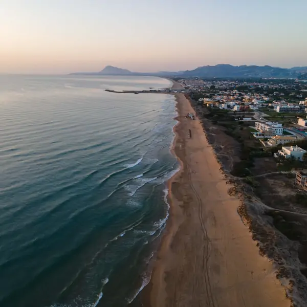 Aerial view of the serene coastline near Suniai Oliva Retreat Center in Spain, showcasing calming waves and tranquil surroundings.