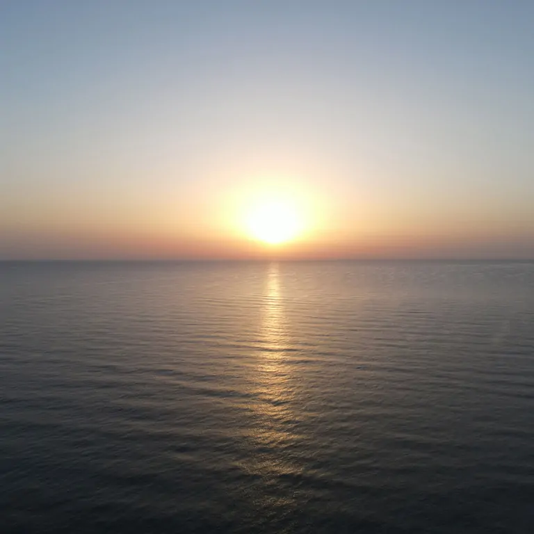 a sunset in the sea of south spain, where oliva beach at Suniai Retreat Center